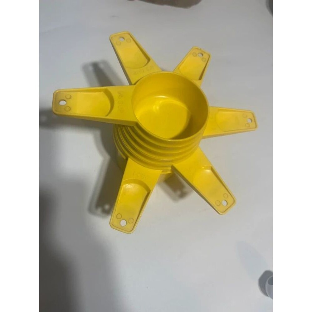 Vintage yellow Tupperware measuring cups